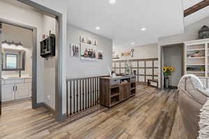 Looking into the half bath off of the large family room area. Access to the primary bedroom through the doorway in the rear right.