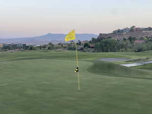 View of community featuring golf course view, a mountain view, and a putting area
