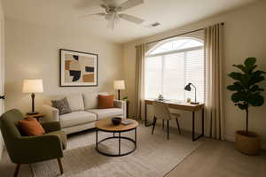 Living area with an office area, carpet flooring, ceiling fan, and baseboards
