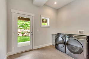 Laundry room featuring independent washer and dryer, light carpet, baseboards, and recessed lighting