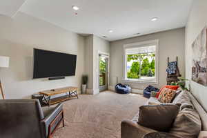 Living room featuring carpet flooring, recessed lighting, and baseboards