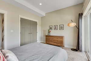 Carpeted bedroom with baseboards and recessed lighting