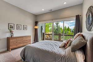 Carpeted bedroom with baseboards and recessed lighting