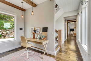 Office featuring beamed ceiling, baseboards, and wood finished floors