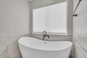 Full bath with a freestanding bath and plenty of natural light