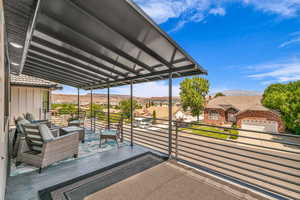 View of patio with a balcony, a residential view, and a mountain view