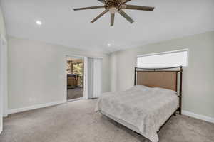 Bedroom with carpet, baseboards, recessed lighting, and access to exterior