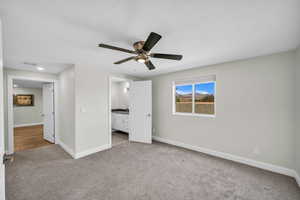 Unfurnished bedroom with carpet, baseboards, and ceiling fan