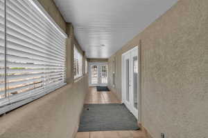Hallway featuring french doors