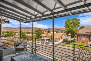 Balcony featuring a residential view and a mountain view