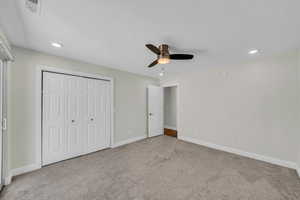 Unfurnished bedroom featuring carpet flooring, baseboards, a closet, recessed lighting, and ceiling fan