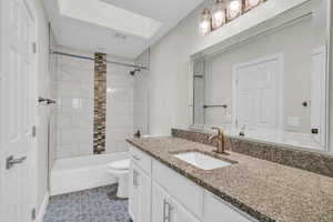 Full bath with vanity, toilet, and shower / washtub combination