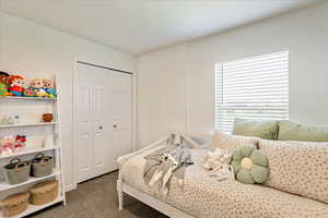 Bedroom featuring carpet floors and a closet