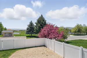 Fenced yard featuring a mountain view