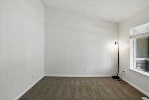 Unfurnished room with carpet and baseboards