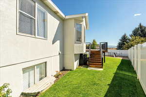 Fenced backyard with stairway and a wooden deck