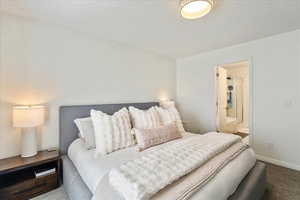 Carpeted bedroom featuring baseboards