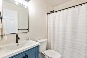 Full bath featuring vanity and a shower with shower curtain