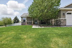 View of front facade with stone siding and stucco siding