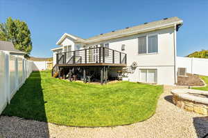 Rear view of property featuring a fenced backyard, a wooden deck, stucco siding, and stairway