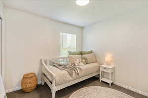 Bedroom featuring dark carpet