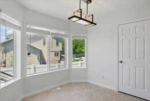 Unfurnished dining area featuring tile patterned floors and baseboards