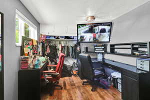 Office space with wood finished floors and a textured ceiling