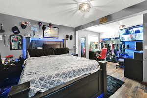 Bedroom featuring hardwood / wood-style floors and a textured ceiling