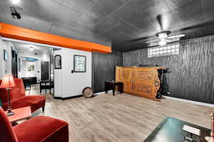 Workout room with ceiling fan, wood finished floors, and baseboards
