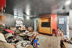 Living room featuring wood finished floors and wallpapered walls