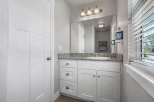 Half Bathroom with vanity and tile patterned flooring