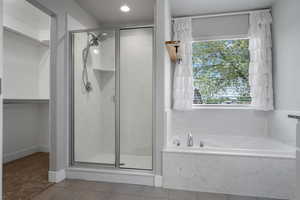 Master Bathroom with a shower stall, a garden tub, tile patterned floors, a walk in closet, and recessed lighting