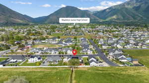 Aerial overview of property's location featuring mountains and nearby suburban area
