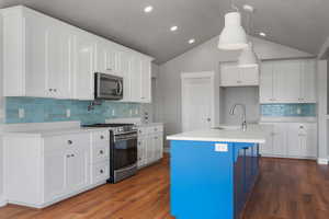 Kitchen featuring appliances with stainless steel finishes, a sink, tasteful backsplash, light countertops, and recessed lighting
