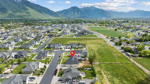 Aerial view of property's location featuring a mountain backdrop and nearby suburban area