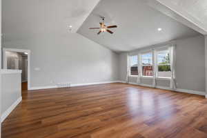 Unfurnished living room with ceiling fan, vaulted ceiling, wood finished floors, baseboards, and recessed lighting