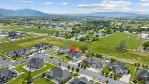 Aerial overview of property's location featuring nearby suburban area and mountains