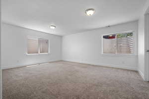 Bedroom featuring baseboards and a textured ceiling