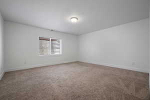 Bedroom with baseboards and carpet
