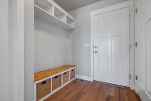 Mudroom with wood finished floors and baseboards