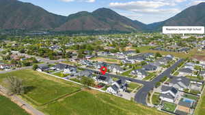 Aerial view of property's location with nearby suburban area and mountains