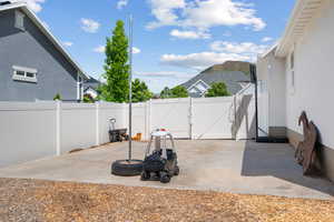 Fenced backyard featuring a gate, a patio area, and a mountain view