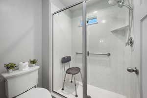 Jack and Jill Bathroom featuring a shower stall and toilet