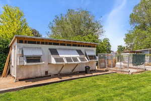 Rear view of property with an outbuilding