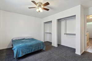 Carpeted bedroom featuring baseboards and ceiling fan