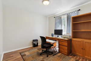 Office space featuring wood finished floors and baseboards