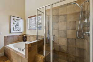 Full bathroom with a garden tub and a shower stall