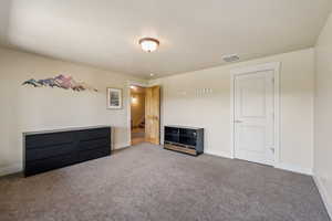Unfurnished bedroom with carpet flooring and baseboards