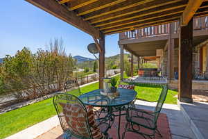 View of patio with outdoor dining space and a mountain view