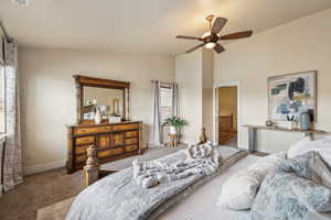 Bedroom with carpet, lofted ceiling, baseboards, and a ceiling fan